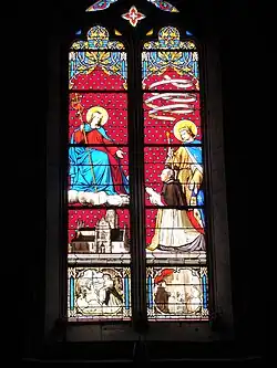 Vitrail de l'abbé Taury offrant l'église Notre-Dame au Christ.