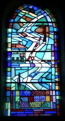 Vitrail de S-Laurent à Châtel : « La charité n'a pas de frontières. »