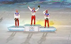 Vue de loin du podium des 50&nbsp;kilomètres des Jeux de Sotchi, le vainqueur levant les bras en l'air.