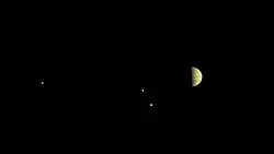 Jupiter et ses plus grosses lunes prises par JunoCam le 28 juin 2016 à environ 6,8&nbsp;millions de km quelques jours avant la mise en orbite.