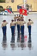 USMC drill instructors salute the national ensign during a graduation ceremony at MCRDPSD, 2013