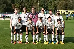 une équipe de football habillé en blanc pose pour la photo