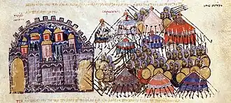 Photographie présentant une page de texte arabe rédigé en rouge, comportant une miniature très colorée représentant le siège de la ville.