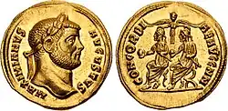 Aureus représentant Maximien tête laurée à l'avers; accompagné de l'inscription MAXIMIANVS AUGVSTVS. Au revers, Dioclétien et Maximien, tous deux casqués et drapés, assis sur des chaises curules, tenants un globe de la main droite et un parazonium de la main gauche. Ils sont couronnés par la Victoire avec l'inscription CONCORDI AE AVGG NN (la concorde des deux Augustes).