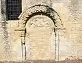 L'ancien portail de l'église avec tympan sculpté.