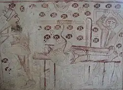 Fresque du XVe&nbsp;siècle montrant les tortures de saint Elme (entrailles enroulées autour d'un treuil), église Sainte-Marie de Båstad, Suède.