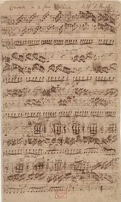 Partition manuscrite à trois portées.