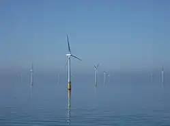 Plusieurs éoliennes en mer.