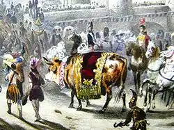 Image colorée figurant un bœuf entouré de cavaliers et d'hommes avec des massues et des coiffes à plumes