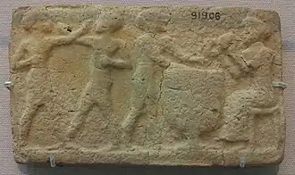 Deux hommes boxant et deux musiciens jouant du tambour et du claquoir. Larsa, British Museum.