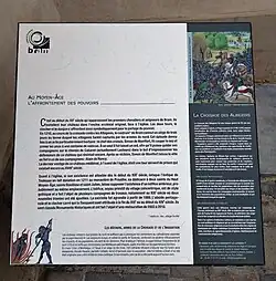 Un des cartels du « chemin du patrimoine » situé à côté de l'église Saints-Julien-et-Basilisse.