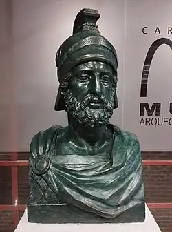 Buste en plâtre. Il représente un homme barbu, en uniforme militaire antique avec un casque sur la tête