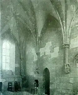 Photographie en noir et blanc d'une pièce voûtée en ogives.