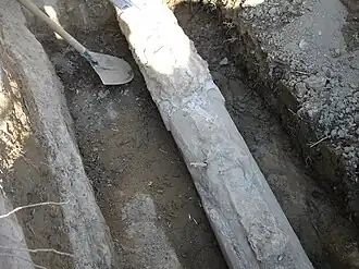 Une partie des canalisations en ciment, datant de 1876, du réseau d'alimentation des fontaines, pendant réparation et pose d'un robinet en 2006.