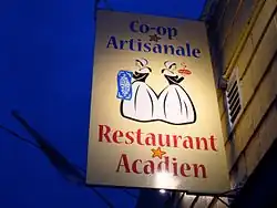 Un gros plan de l'affiche de la coop artisanale de Chéticamp faisant un usage décoratif de Stella Maris.