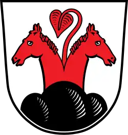 Dessin d'un blason avec deux têtes de chevaux de couleur rouge, chacune tournée vers les extérieurs droite et gauche. Entre les deux, pousse une plante, également rouge, avec une feuille unique.