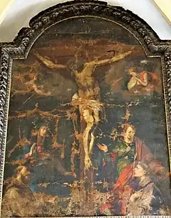 Crucifixion de Jésus entre la Vierge Marie et saint Jean avec deux capucins en adorant.