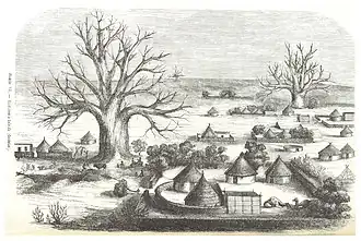 Gravure en noir en blanc, village de cases rondes aux toits coniques