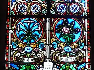 Vitrail de la Rosa mystiqua et du Lys à l'église d'Excideuil (Dordogne).