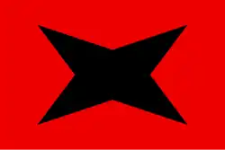 Drapeau comportant une étoile noire à quatre branches sur fond rouge.