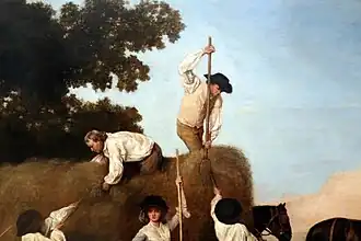 Travailleurs agricole sur la charrette de foin