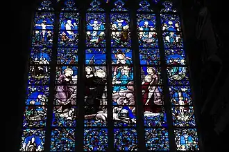 Vitrail à dominante bleue intense représentant une adoration.