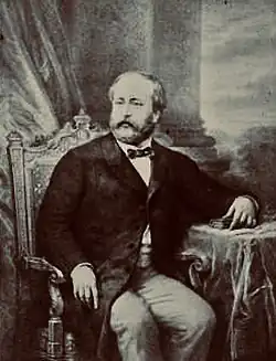 Portrait d'un homme assis à une table.