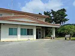 Photographie couleur d'un bâtiment en forme de maison à un étage.