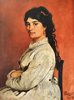 L'épouse de Léon Philippet, Michelina, pose assise de trois quarts, les bras croisés, le visage tourné vers le spectateur. La jeune femme porte une robe claire au col plissé, sans doute son habit du dimanche. Sa lourde chevelure noire est retenue en arrière par un peigne de corail auquel fait écho la pendeloque accrochée à son oreille gauche.