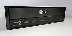 The M-DISC "swirl" logo on an LG Blu-ray optical drive.