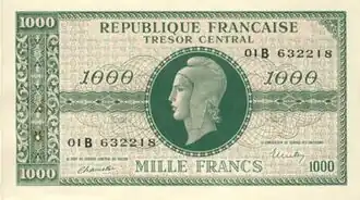 Photographie en couleurs d'un billet de banque imprimé en vert foncé sur crème.
