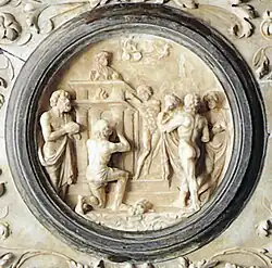 bas-relief circulaire représentant des hommes lors d'un sacrifice.