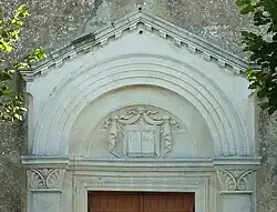 Le tympan : sur les pages du livre est gravé « LA BIBLE ».