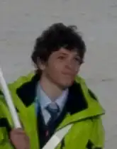 Portrait en buste d'un jeune homme portant un manteau vert clair.