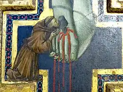 Détail : saint François d'Assise baise les pieds du Christ.