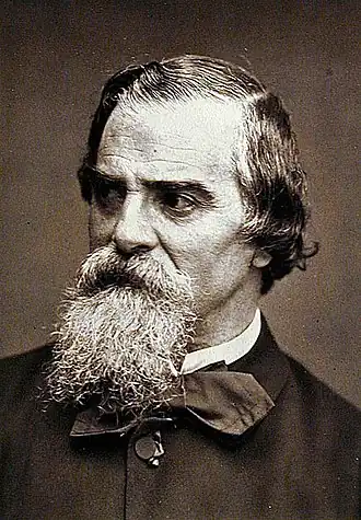 Portrait photographique sépia d’un homme âgé barbu.