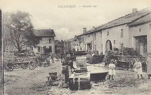 Carte postale du village vers 1910, avec la fontaine-lavoir au milieu de la place.