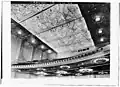 1932 image of auditorium ceiling and balcony soffit. Round holes in balcony edge are for stage lighting instruments. Dark windows in far wall are for film projectors and spotlights.[Traduire&nbsp;passage]