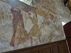 Caïn et Abel près de l'entrée, offrande et meurtre avec une pelle triangulaire.