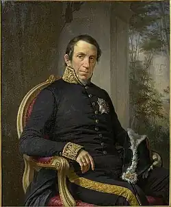 Un homme, le Baron Louis de Schiervel, portant des vêtements militaires pose assis.