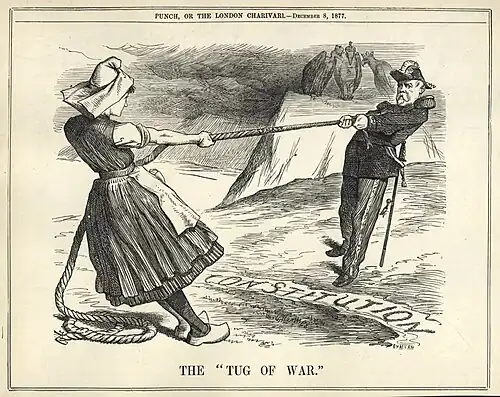 Dessin de presse montrant un homme et une femme jouant au tir à la corde. À l'arrière-plan, trois oiseaux de proie coiffés chacun d'une couronne sont perchés sur un rocher.