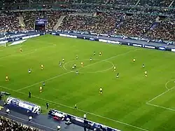 Les joueurs de l'US Quevilly et de l'Olympique lyonnais évoluant sur la pelouse du Stade de France lors de la finale de la Coupe de France 2012.