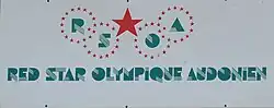 Photographie du logo du « Red Star Olympique Audonien », écrit en vert.