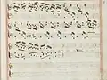 partition manuscrite rehaussée de couleurs passées rouge et bleu en bordures