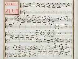 partition manuscrite rehaussée de couleurs passées rouge et vert en bordures et cadre de titre, titre en rouge