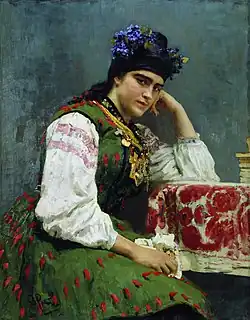 Portrait d'une femme assise, aux habits colorés.