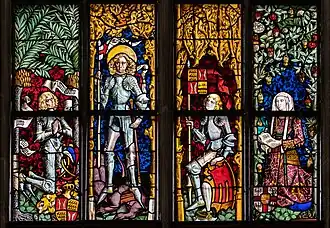 Partie inférieure d'un vitrail montrant le patron et fondateur de la Stiftskirche (Tübingen)&nbsp;(de). Ce vitrail a été réalisé par Peter Hemmel von Andlau vers 1578. Sur la gauche est représenté Eberhard V de Wurtemberg, fondateur de l'université de Tübingen, au milieu Georges de Lydda, le patron de l'église, l'identité du personnage suivant est incertaine, et à droite Barbara Gonzaga, première duchesse consort du Wurtenberg.