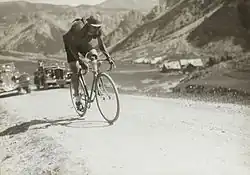 Photographie en noir et blanc d'un cycliste dans l'ascension d'un col.