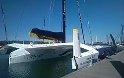 Coque centrale et flotteur tribord. L'arrière du bateau est blanc, au contraire de l'avant, qui est bleu sombre.