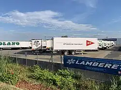 Semi-remorques stationnées en sortie d'usine.